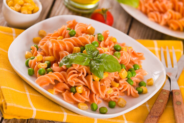 Fusilli pasta with peas and sweet corn.
