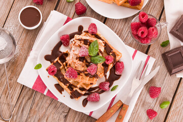Waffles with raspberries and chocolate cream.
