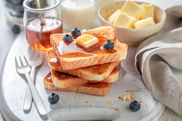 Tasty and fresh french toast with honey and fresh berries.