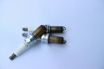 old spark plugs on a white background