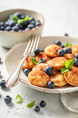 Dutch and sweet mini pancakes with fresh berries.