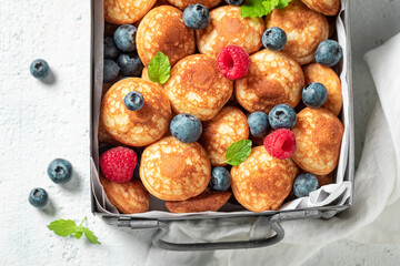 Homemade and fresh poffertjes with fresh berries.