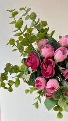 Top view of an artificial roses bouquet in white background