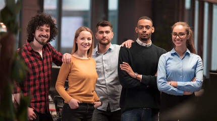 Portrait of successful creative business team looking at camera and smiling. Diverse business people standing together at startup. Selective focus 