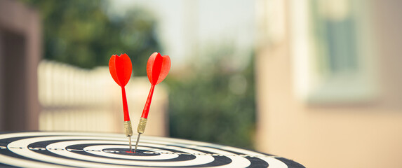Bullseye or Bulls eye target or dartboard has dart arrow throw hitting the center of a shooting for...
