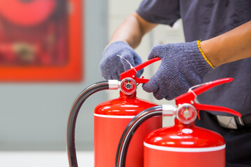Fire extinguisher has engineer inspection checking handle prepare fire equipment for protection and prevent emergency and safety rescue and alarm system training concept.