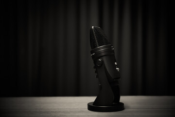 Close-up podcasting microphone on table equipment for sound studio record producer and audio editor...