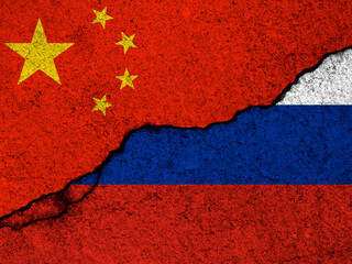 China and Russia relationships background. Country flags painted on cracked concrete walls