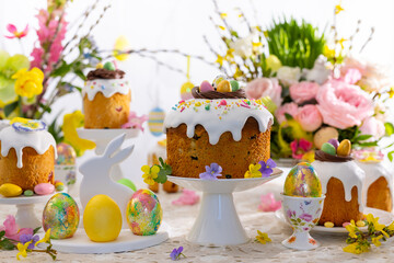 Festive Easter table setting. Easter cake, Easter Eggs, Flower arrangements and home decorations for holiday.