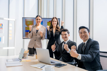 Four handsome Asian businessmen are meeting together at the company. Showing a very happy expression. The concept is teamwork, marketing, teamwork, finance.