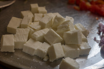 selective focus of cube pieces of Indian cheese.