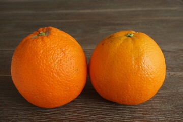 two oranges isolated on wooden table