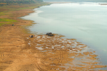 view of a river bed with tractors and workers