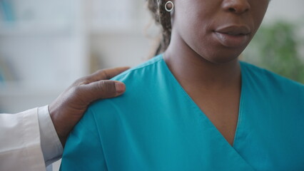 Male physician touching female colleague's shoulder, sexual harassment at work place - obrazy, fototapety, plakaty