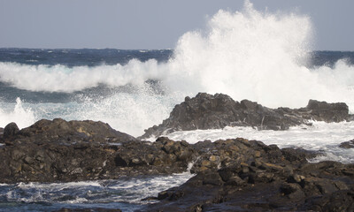 Fototapeta na wymiar Waves breaking against the shore. El Confital. La Isleta Protected Landscape. Las Palmas de Gran Canaria. Gran Canaria. Canary Islands. Spain.