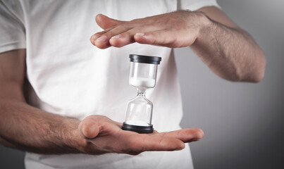 Man holding hourglass. Deadline concept