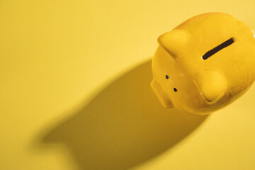 Yellow piggy bank on the yellow background.