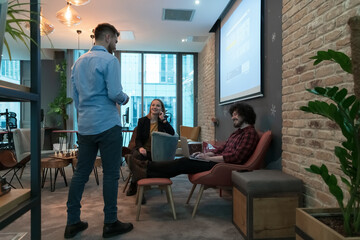 Successful team. Group of young business people working and communicating together in creative office. Selective focus 