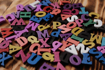 Multicolored letters of the alphabet. Volumetric multicolored letters. The alphabet is in a chaotic...