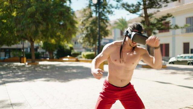 Young man boxing using virtual reality glasses at park