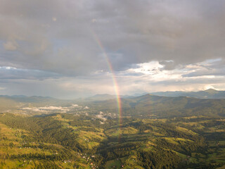 Rainbow in the mountains of the Ukrainian Carpathians. Aerial drone view.