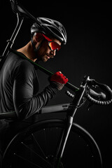 Fototapeta na wymiar male cyclist with road bicycle on black background