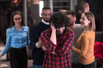 A group of young business people have fun playing interesting games while taking a break from work in a modern office. Selective focus 
