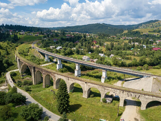 Old railway bridge in the mountains. Ukrainian Carpathians. Aerial drone view.