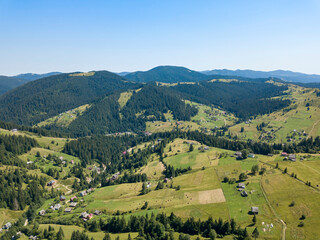Obraz premium Green mountains of Ukrainian Carpathians in summer. Sunny clear day. Aerial drone view.