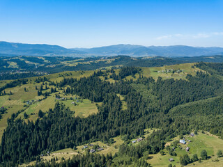 Naklejka na ściany i meble Green mountains of Ukrainian Carpathians in summer. Sunny clear day. Aerial drone view.