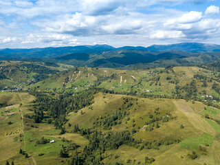 Obraz premium Green mountains of Ukrainian Carpathians in summer. Coniferous trees on the slopes. Aerial drone view.