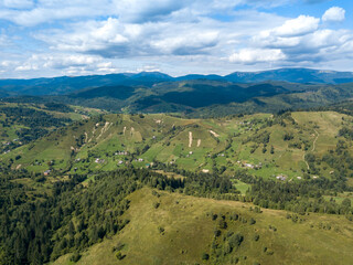 Fototapeta premium Green mountains of Ukrainian Carpathians in summer. Coniferous trees on the slopes. Aerial drone view.