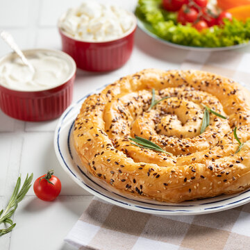 Homemade borek (burek)  vertuta snail  pie  with cottage cheese close-up on the table