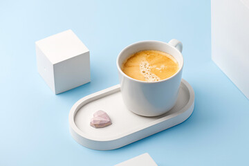 One coffee cup with espresso or cappuccino on beton tray and podiums. Aroma, ristretto. Mug of coffee. Blue background. Modern