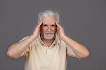 Headache in the elderly, Senior holds his head