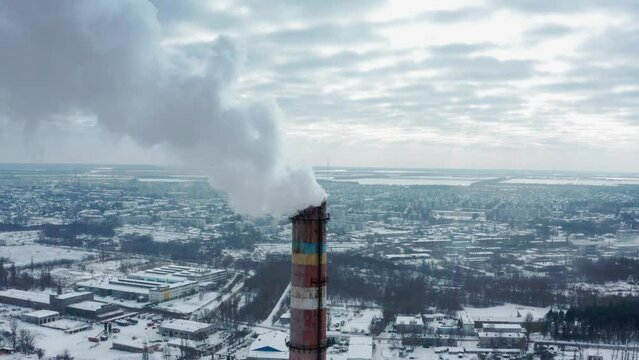 Air environment pollution concept. Smoke or hot steam from tube chimney of power chemical petrochemical oil and gas refinery plant complex. Industrial winter landscape. TPP. TPS. Flying towards