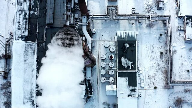 Pollution of the atmosphere by an industrial enterprise of the TPS station.  Smog smoke carbon and pollution emissions from industry smokestacks.   Top view to the Close up pipe with smoke.