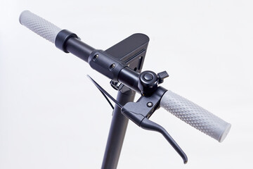 E-scooter handles. Electric folding scooter in dark color. Bell on handlebar of electric scooter.