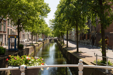 Narrow canal in the center of the historic city of Delft in the Netherlands.