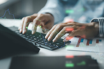 Close-up of hands resting on keyboard to view financial data, business growth in the world of cryptocurrencies and the current global economy with war and volatility. Finance and investment concepts.
