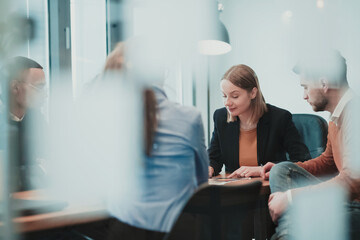 Successful team. Group of young multi-ethnic business people working and communicating together in creative office. Selective focus 