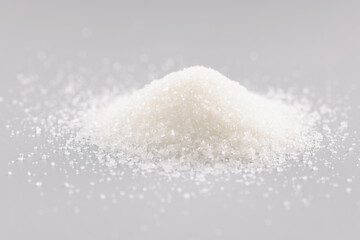 Sugar crystals pile on grey background, heap of sweet powder, sugar substitute