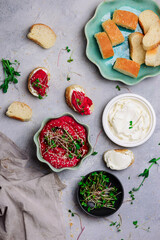 Beetroot hummus with micro greens. top view .
