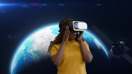 Obraz na płótnie Canvas Excited African woman wearing virtual reality headset with space on background