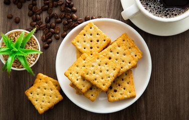 Biscuit with chocolate filling on wooden background