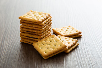 Biscuit with chocolate filling on wooden background