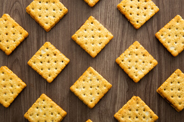Biscuit with chocolate filling on wooden background