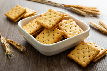 Biscuit with chocolate filling on wooden background