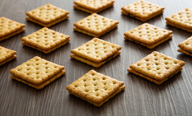 Biscuit with chocolate filling on wooden background