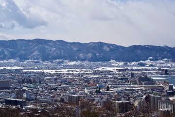The view of Suwa city with some snow in winter.